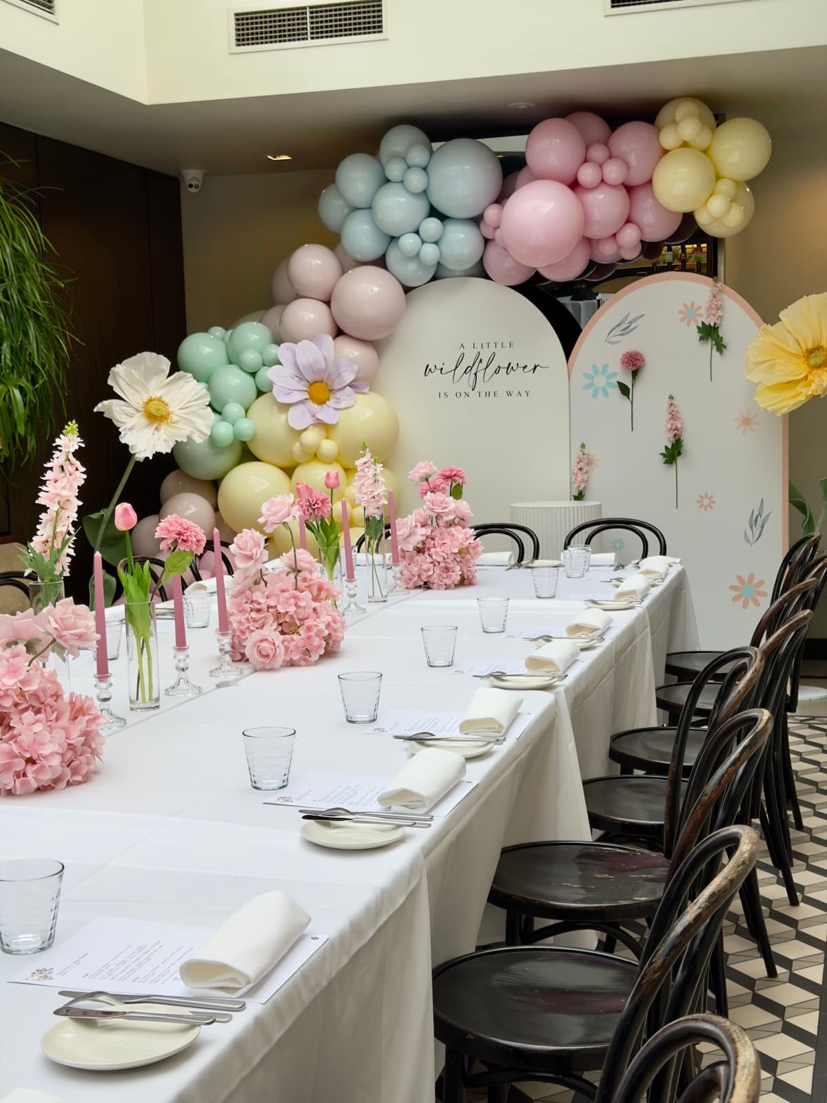 Baby shower event styling with pastel decorations and balloon arrangements