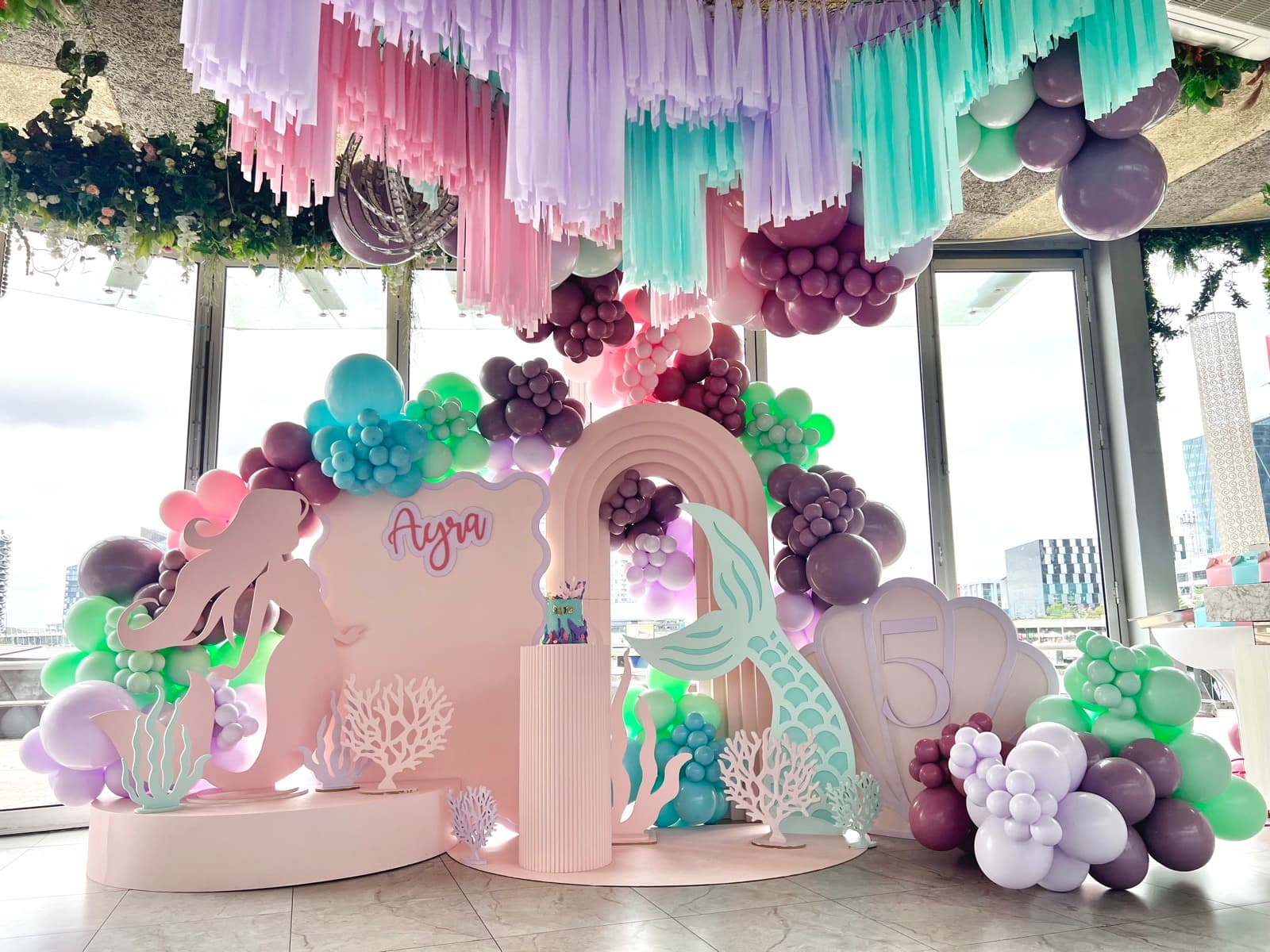 Birthday party styling with balloon installations and themed decorations
