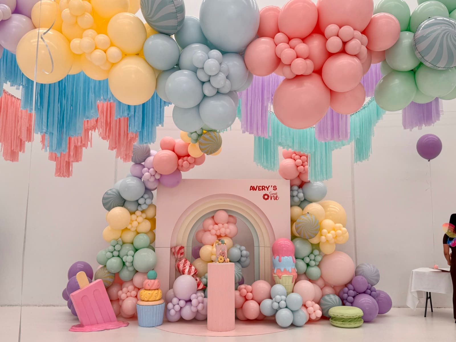 Birthday party styling with balloon installations and themed decorations
